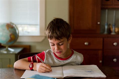 Little Boy Crying While Doing His Homework By Stocksy Contributor