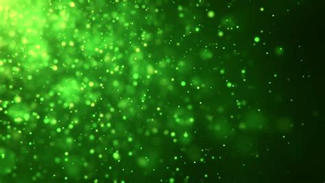 Sparkly Gold And Silver Light Particles Moving Across A Green Gradient