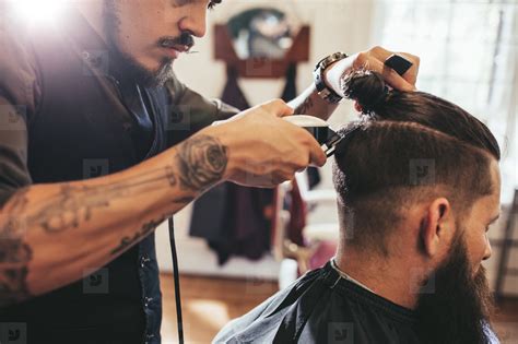 Man Getting Trendy Haircut In Barber Shop Stock Photo 125837