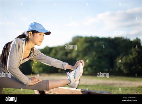 Young Female Runner Stretching Legs Stock Photo Alamy