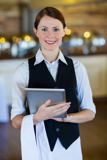 Premium Photo Portrait Of Smiling Waitress Holding Digital Tablet
