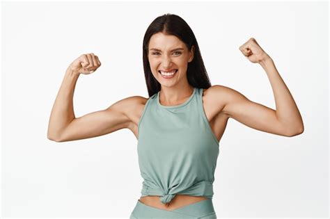 Premium Photo Strong Beautiful Woman Flexing Biceps Showing Muscles