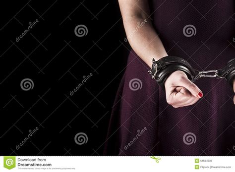Submissive Woman Wearing A Purple Dress In Leather Handcuffs On Stock