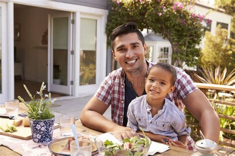 father and son eating outdoor meal in garden together stock image image of caucasian outdoors