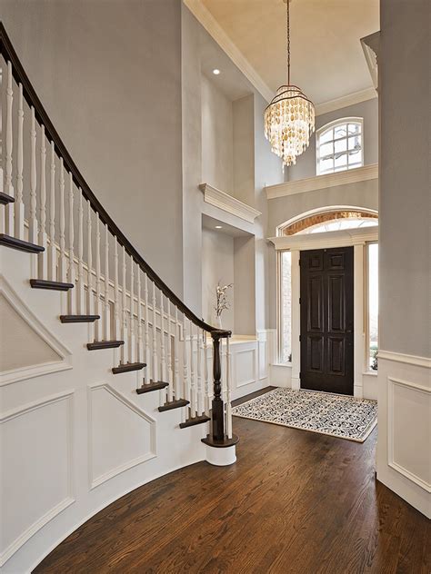 Traditional Gray Foyer With Spiral Staircase And Wall