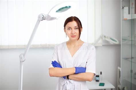 Portrait Of Attractive Young Woman Cosmetologist Doctor In White