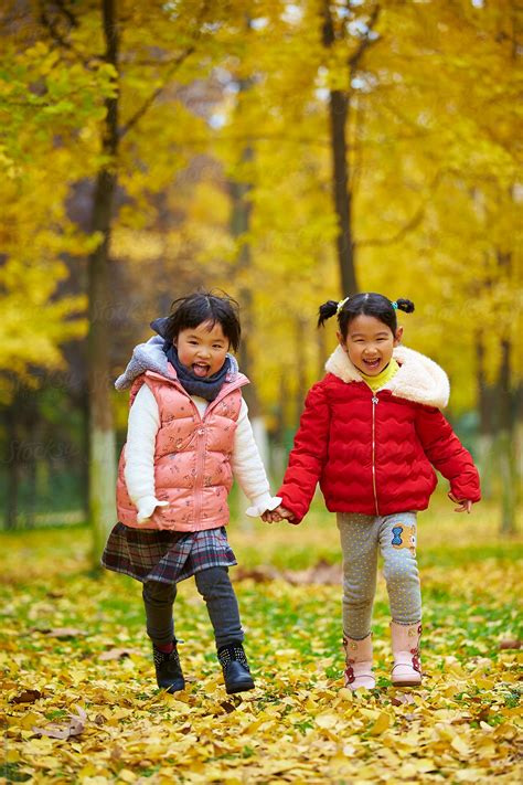 Two Lovely Asian Girl Having Fun In The Autumn Woods Del Colaborador De Stocksy Bo Bo Stocksy
