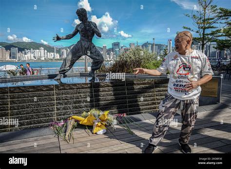 A man poses the same way as the statue of the statue of Bruce Lee in