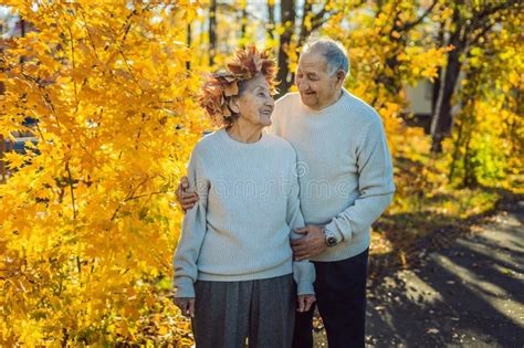 Happy Old Couple Having Fun At Autumn Park Elderly Man Wearing A