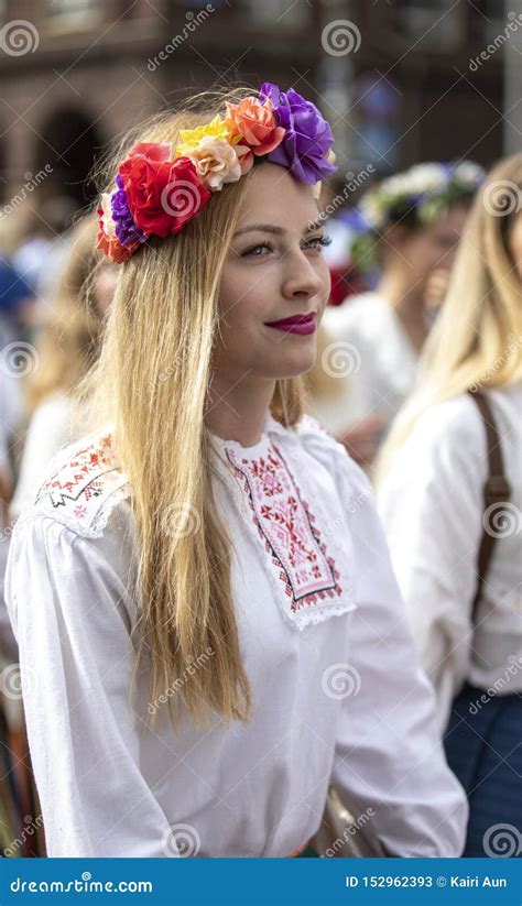 Estonian People In Traditional Clothing Walking The Streets Of Tallinn