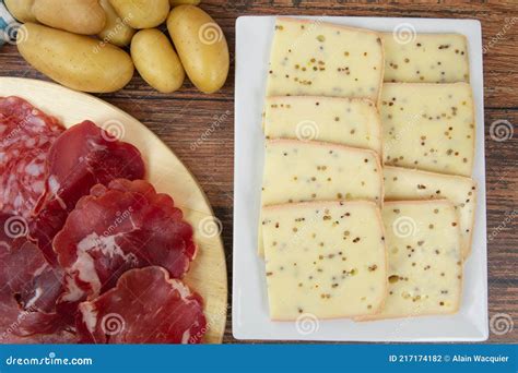 Raclette Cheese And Cold Cuts On A Table Stock Photo Image Of