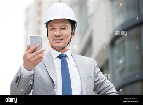 Chinese Male Architect Using Smart Phone Outdoors Stock Photo Alamy