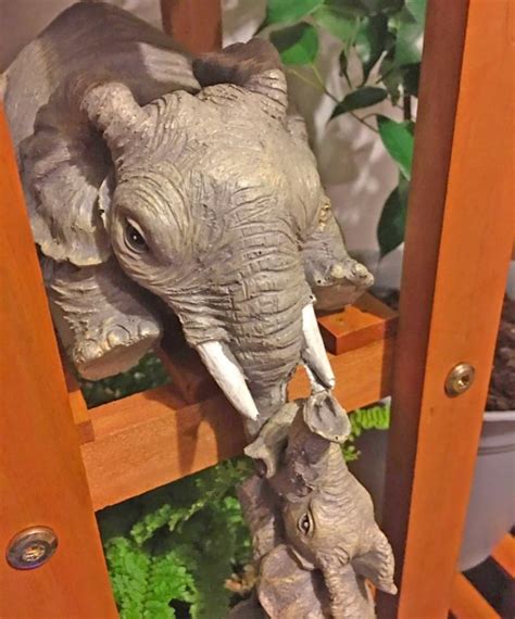 This Elephant With Hanging Baby Elephants Bookend Statue Is Just Too