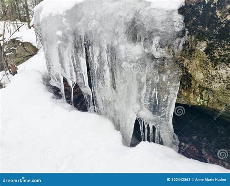 Frozen Water Icicles Stalagmites On Rock In Mountains With Snow Stock