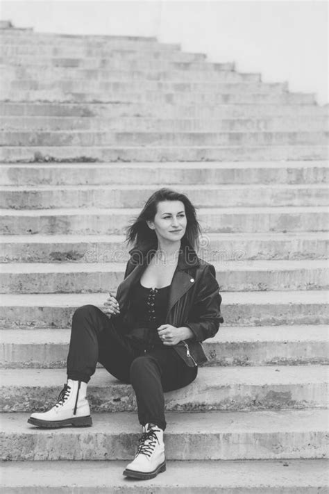 Beautiful Young Woman Sitting On A Concrete Staircase Stock Photo