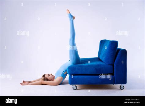 Good Looking Calm Woman Holding Her Legs Up On The Sofa Stock Photo Alamy