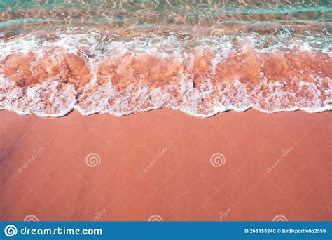 Aerial View Of A Sandy Beach With Waves Breaking On The Shore Stock