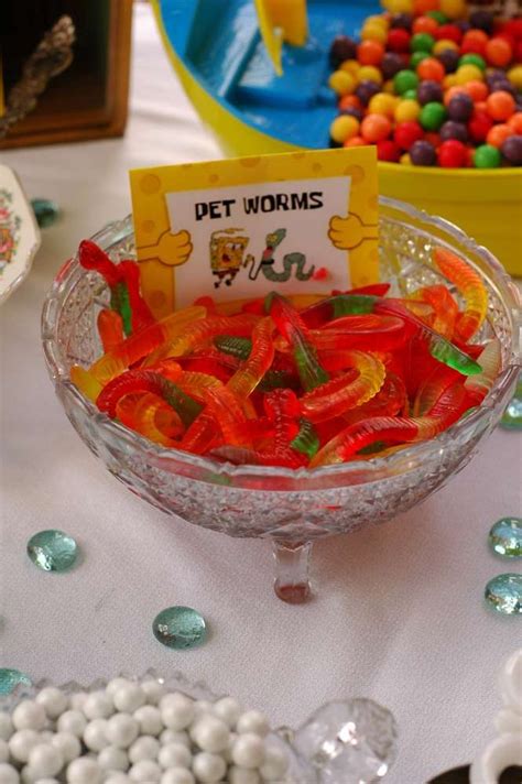 A Bowl Filled With Gummy Bears Sitting On Top Of A Table Next To Other