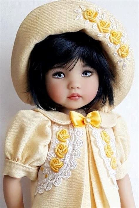 A Doll Wearing A Yellow Dress And Hat With Flowers On Its Head Is