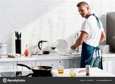 Adult Man Washing Dishes Kitchen Stock Photo AndrewLozovyi 224643634