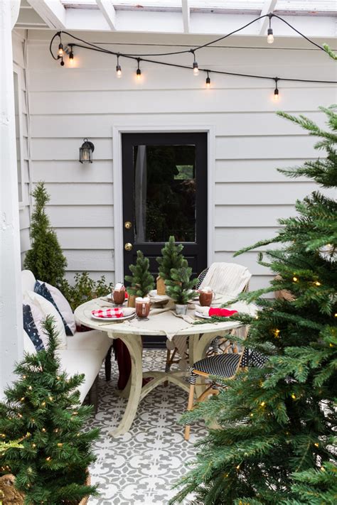 She often prefers simple potted plants on her outdoor tables. Simple Outdoor Christmas Table Decorating - A Christmas Tablescape Tour - zevy joy