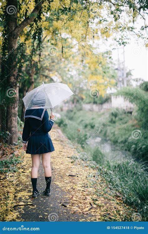 Portrait Of Asian School Girl Walking With Umbrella Stock Photo Image