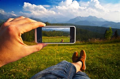 Man Taking A Photo Of A Landscape With His Phone Point Of View Stock