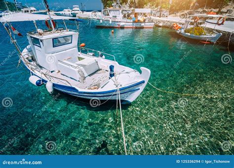 Traditional Fishing Boat In Crystal Clear Mediterranean Sea Blue Bay