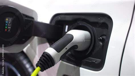 Stockvideo Electric Vehicle Charging Port Plugging In Ev Modern Car