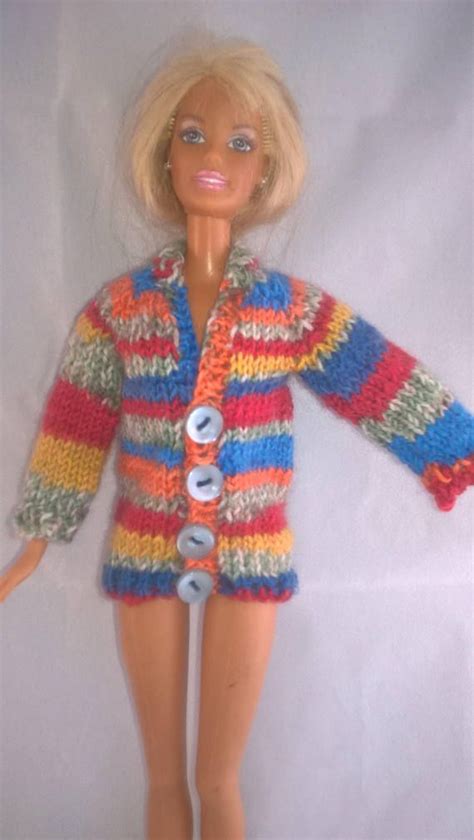 A Barbie Doll Wearing A Multicolored Knitted Jacket And Pants With