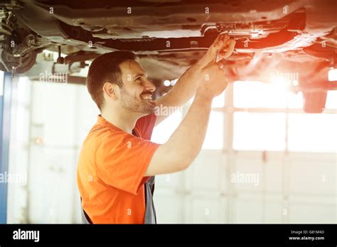 Car Mechanic Fixing A Car In Garage At Dealership Stock Photo Alamy