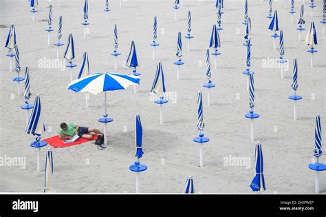 Social Distancing Lone Man On Beach Calgary Sardinia Italy Stock