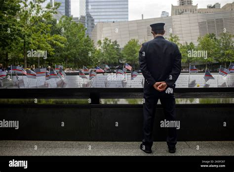 A service member pays respects at the National September 11th Memorial