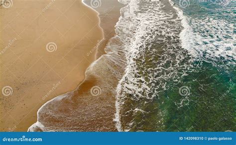 Multicolored Aerial View Of Sea Waves Splashing On Sandy Beach Stock
