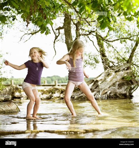 Smiling Girls Playing In Lake Stock Photo Alamy C