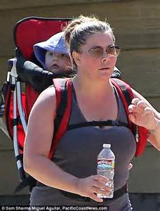 Nicole Eggert Straps Daughter On Her Back As She Puffs Her Way Through