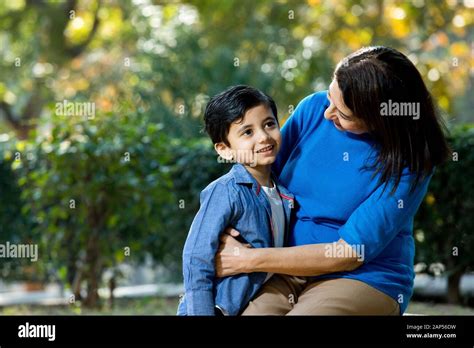 Loving grandmother embracing her grandson at park Stock Photo - Alamy