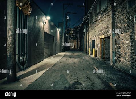 Dark and eerie urban city alley at night Stock Photo - Alamy