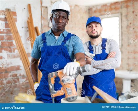 Focused Builders Posing On Indoor Construction Site Stock Photo Image