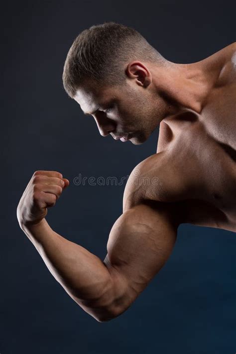 Strong Fit Man Demonstrating His Powerful Muscles Stock Photo Image