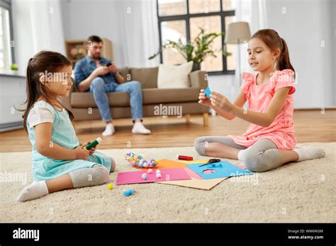 Happy Sisters Doing Arts And Crafts At Home Stock Photo Alamy