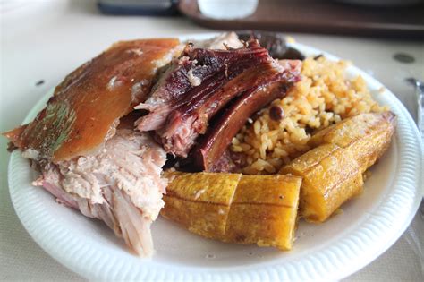 Lechon Roasted Pig Plantain Rice And Pigeon Peas Blood Sausage