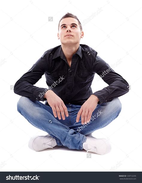 Stock Photo Casual Young Man Sitting Cross Legged On The Floor And