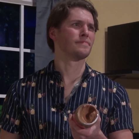 A Man Holding A Donut In His Right Hand