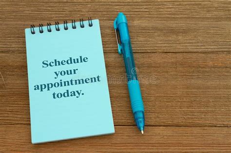Schedule Your Appointment Today On A Notepad On Wood Desk Stock Photo