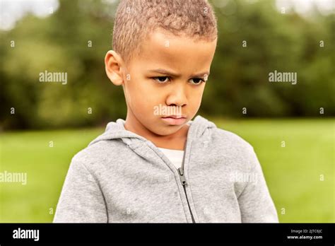 Portrait Of Unhappy Little Boy At Park Stock Photo Alamy