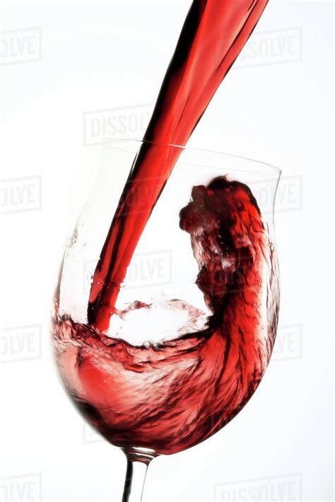 Red Wine Pouring Into Winw Glass Stock Photo Dissolve