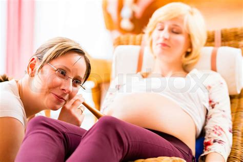Midwife Seeing Mother For Pregnancy Examination Stock Image Colourbox