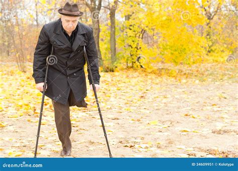 Elderly Disabled Man On Crutches In A Park Stock Image Image Of