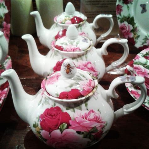 The Tea Set Is Decorated With Pink Flowers